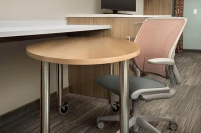 an office desk with a table and a chair at Home2 Suites By Hilton Clovis Fresno Airport in Clovis