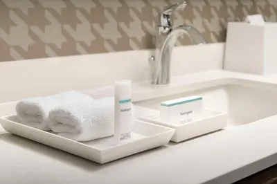 a bathroom counter with towels and a sink at Home2 Suites By Hilton Clovis Fresno Airport in Clovis