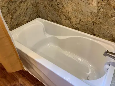 a white bath tub sitting in a bathroom at Pioneer in Oakhurst