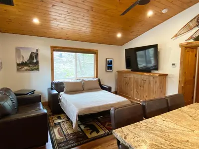 a living room with a couch and a flat screen tv at Pioneer in Oakhurst