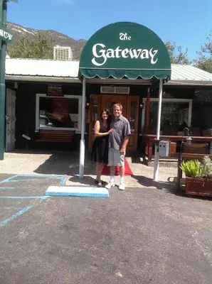 a man and a woman standing in front of a store at The Gateway Restaurant & Lodge in Three Rivers