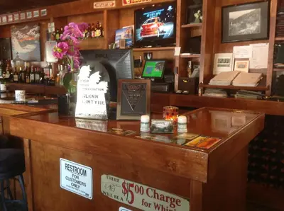 a bar with a sign on top of it at The Gateway Restaurant & Lodge in Three Rivers