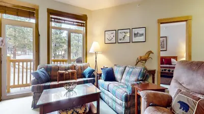 a living room with a couch and a table at Sunstone #322 condo in Mammoth Lakes