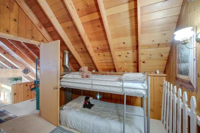 a room with two bunk beds in a cabin at Mountain Tops Ponderosa Getaway Near Dome Rock! in Ponderosa