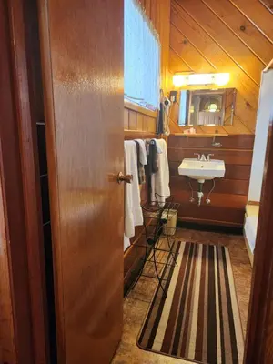 a bathroom with a sink and a mirror and a door at Toiyabe Motel in Walker