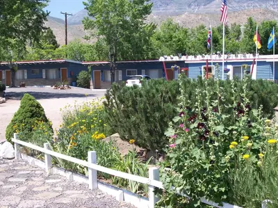 a garden with flowers in front of a building at Toiyabe Motel in Walker