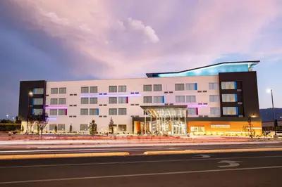 a large white building with purple lights on it at Aloft Reno Tahoe International Airport in Reno