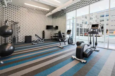 a gym with treadmills and exercise equipment in a building at Aloft Reno Tahoe International Airport in Reno