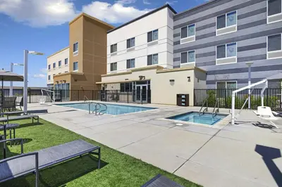 a building with a swimming pool in front of a building at Fairfield Inn & Suites by Marriott Lodi in Lodi