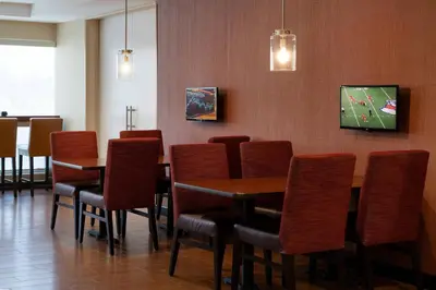 a dining room with wooden tables and chairs at TownePlace Suites Fresno Clovis in Clovis