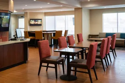 a restaurant with tables and chairs and a bar at TownePlace Suites Fresno Clovis in Clovis