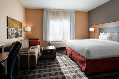 a hotel room with a bed and a couch at TownePlace Suites Fresno Clovis in Clovis