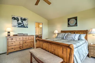 a bedroom with a wooden bed and a dresser at Near Hiking Home with Deck in Twain Harte! in Twain Harte