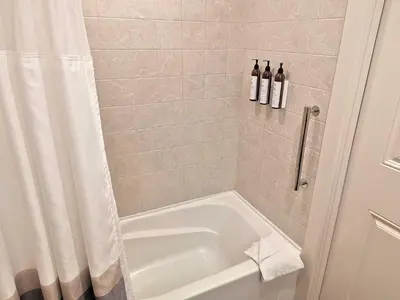 a bathroom with a tub and a shower with two bottles of wine at Marriott Grand Res Q4 #4256 in South Lake Tahoe