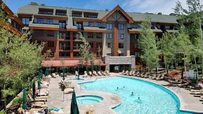 a hotel with a swimming pool and chairs and a building at Marriott Grand Res Q4 #4256 in South Lake Tahoe