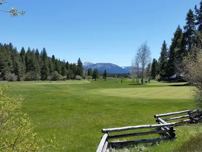 a park with two wooden benches in a field at Marriott Grand Res Q3 #2241 in South Lake Tahoe