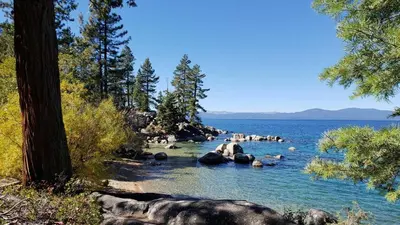 a group of people sitting on rocks in the water at Marriott Grand Res Q3 #2241 in South Lake Tahoe