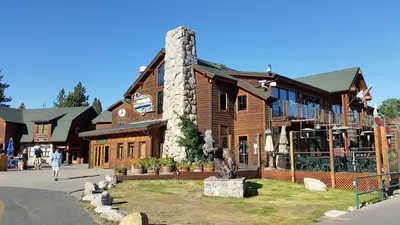 a woman walking past a log building with a statue at Marriott Grand Res Q1 #3256 in South Lake Tahoe