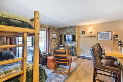 a room with two bunk beds and a desk at Walk to Ski Lift and Village Lovely Kirkwood Condo! in Kirkwood