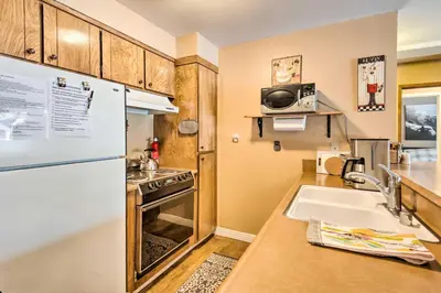 a small kitchen with a sink and a refrigerator at Walk to Ski Lift and Village Lovely Kirkwood Condo! in Kirkwood