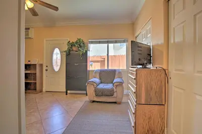 a living room with a chair and a refrigerator at Sacramento Area Apartment 15 Mi to Downtown in Antelope