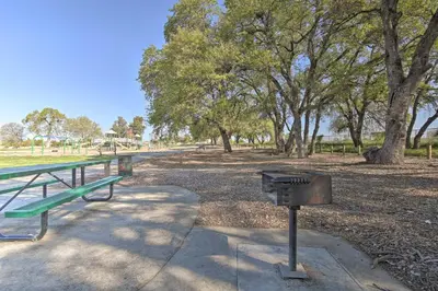 a picnic table and a grill in a park at Sacramento Area Apartment 15 Mi to Downtown in Antelope