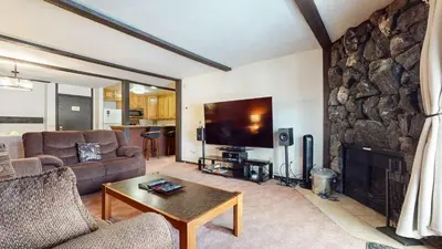 a living room with a couch and a fireplace at Summit #57 condo in Mammoth Lakes
