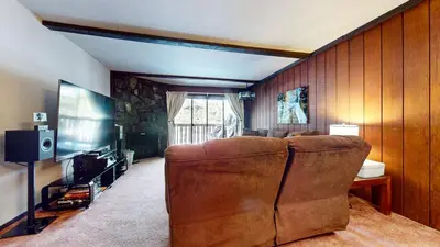 a living room with a couch and a television at Summit #57 condo in Mammoth Lakes