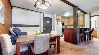a kitchen and dining room with a table and chairs at Summit #57 condo in Mammoth Lakes