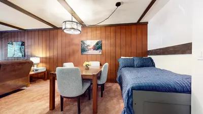 a bedroom with a bed and a table and a desk at Summit #57 condo in Mammoth Lakes