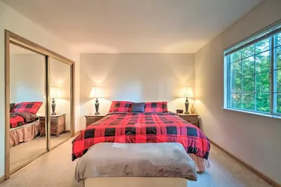 a bedroom with a bed and a mirror at 4 Mi to Big Tree State Park Serene Cabin with Deck in Arnold