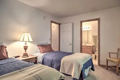 a bedroom with two beds and a lamp on a table at 4 Mi to Big Tree State Park Serene Cabin with Deck in Arnold