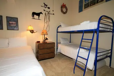 a bedroom with two bunk beds and a ladder at Sierra Park Villas #67 in Mammoth Lakes