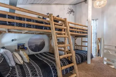 a bunk bed in a room with two beds at Sierra Park Villas 04 in Mammoth Lakes