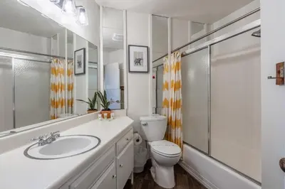 a white bathroom with a toilet and a sink at Sierra Park Villas 04 in Mammoth Lakes
