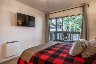 a bedroom with a bed and a large window at Sierra Park Villas 04 in Mammoth Lakes