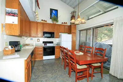 a kitchen with a wooden table and chairs at SIerra Park Villas #06 in Mammoth Lakes