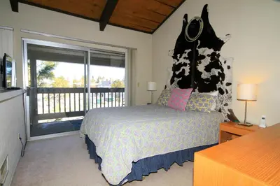 a bedroom with a bed and a large window at Sierra Park Villas 24 in Mammoth Lakes