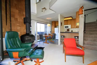 a living room with two chairs and a stove at Sierra Park Villas 24 in Mammoth Lakes