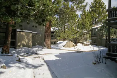 a driveway covered in snow next to a house at Sierra Park Villas 24 in Mammoth Lakes