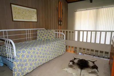 a bedroom with a bed and a cat laying on the floor at Sierra Park Villas 24 in Mammoth Lakes