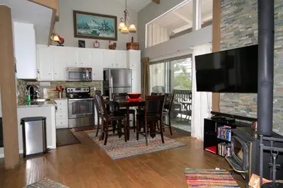 a kitchen with a table and chairs and a television at Sierra Park Villas 03 in Mammoth Lakes
