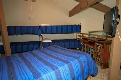 a bedroom with two bunk beds and a tv at Sierra Park Villas 03 in Mammoth Lakes