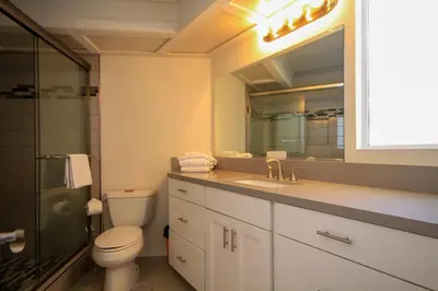 a bathroom with a toilet and a sink and a mirror at Sierra Park Villas 93 in Mammoth Lakes