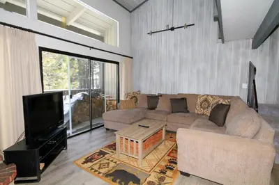 a living room with a couch and a tv at Sierra Park Villas 93 in Mammoth Lakes