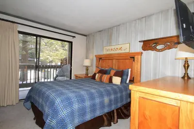 a bedroom with a bed and a large window at Sierra Park Villas 93 in Mammoth Lakes