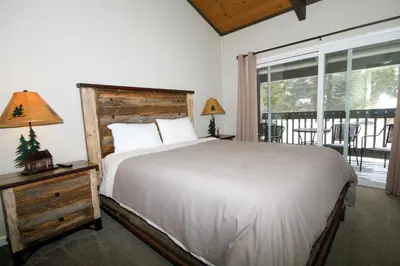 a bedroom with a bed and a large window at Sierra Park Villas 65 in Mammoth Lakes