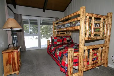 a bedroom with a wooden bunk bed in a room at Sierra Park Villas 65 in Mammoth Lakes