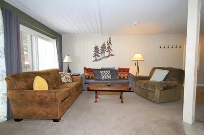a living room with two couches and a table at Sierra Park Villas 65 in Mammoth Lakes