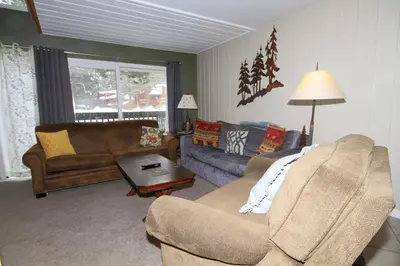 a living room with two couches and a table at Sierra Park Villas 65 in Mammoth Lakes